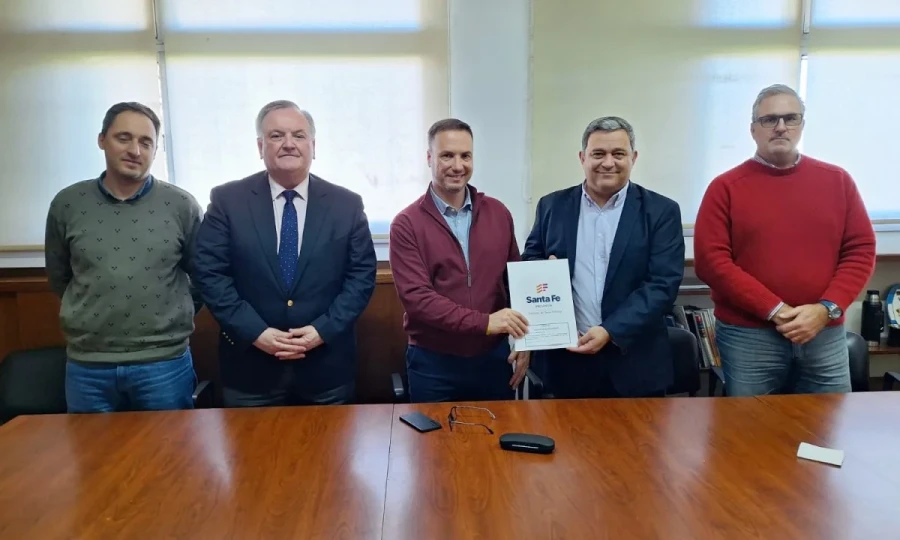 Las autoridades en el acto, Enrico y Piumatti sostienen el  documento firmado.