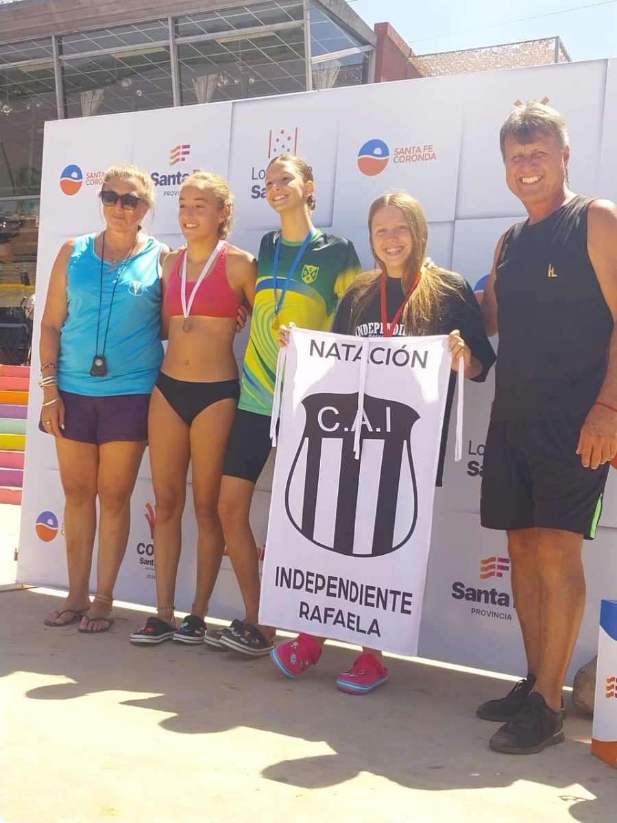 EN EL PODIO. La nadadora de Independiente junto a su padre, el ex futbolista Marcelo L&oacute;pez.