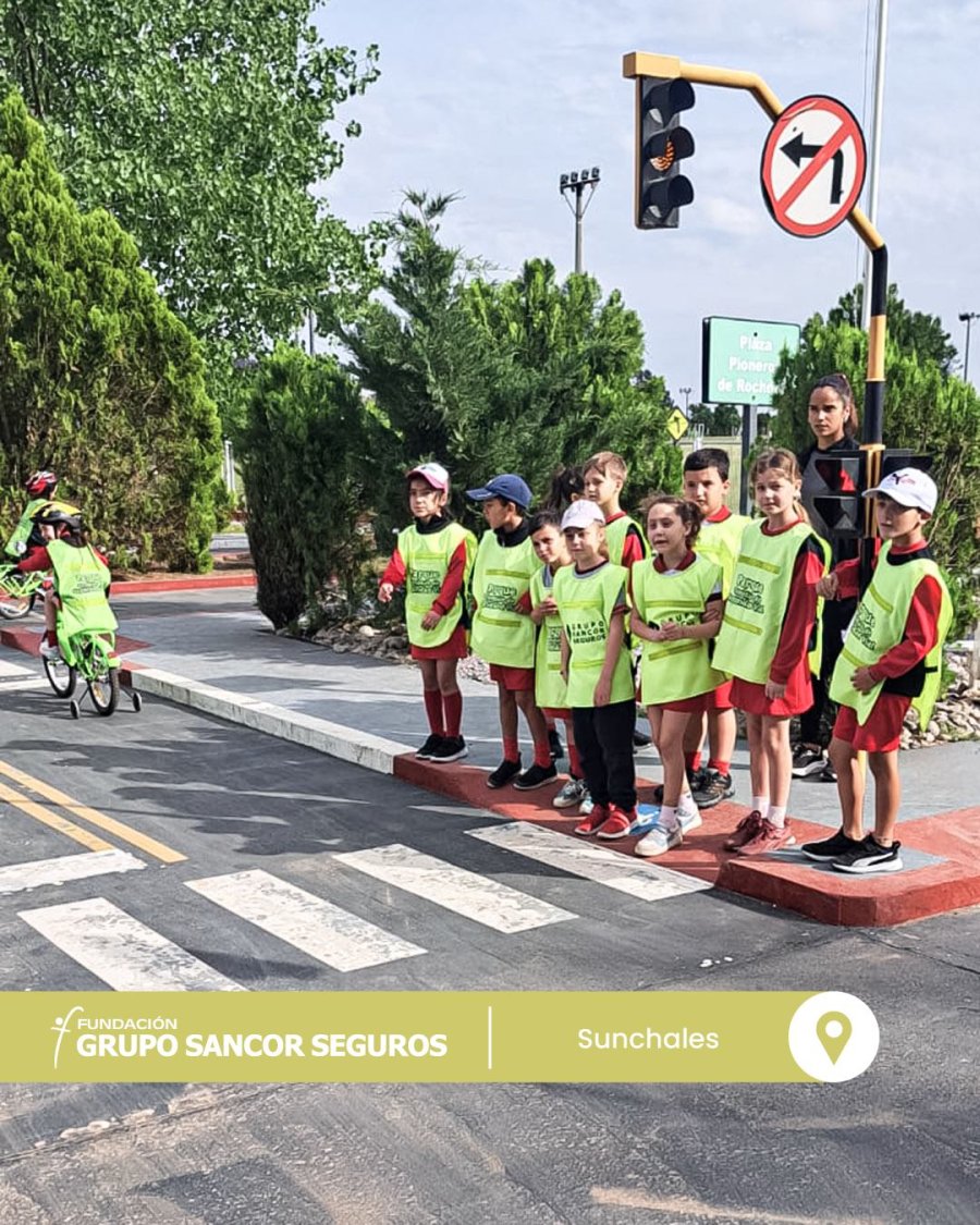 un grupo de escolares aguardando en un sem&aacute;foro.